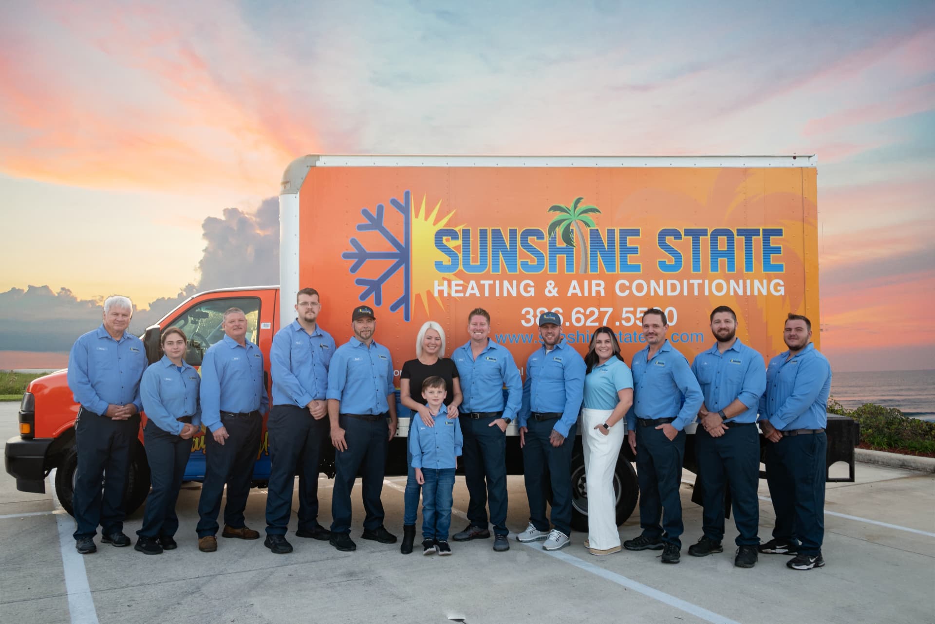 The Sunshine State Heating & Air team in front of the company box truck at sunset