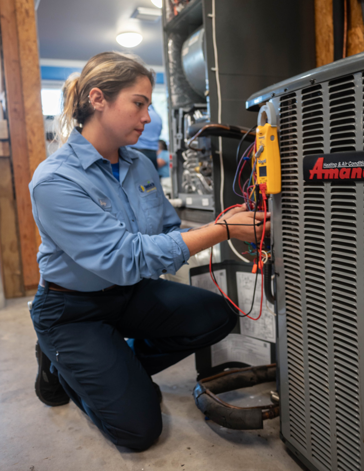 Sunshine State technician taking meter readings at an indoor air handler and duct connection